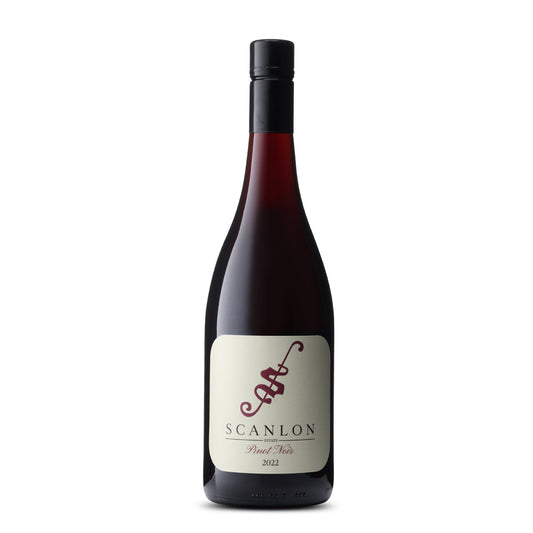 A bottle of Scanlon Estate Pinot Noir 2022. The bottle has a tapered design with a cream-colored label featuring the name 'SCANLON' in bold, dark letters and 'Pinot Noir 2022' underneath. The background is plain, accentuating the dark red to purple gradient of the wine visible through the clear glass